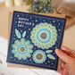 Hand holding unique floral Happy Mother's Day card Blue green floral illustration for flower-loving mums Printed on recycled card Supplied with kraft brown recycled envelope