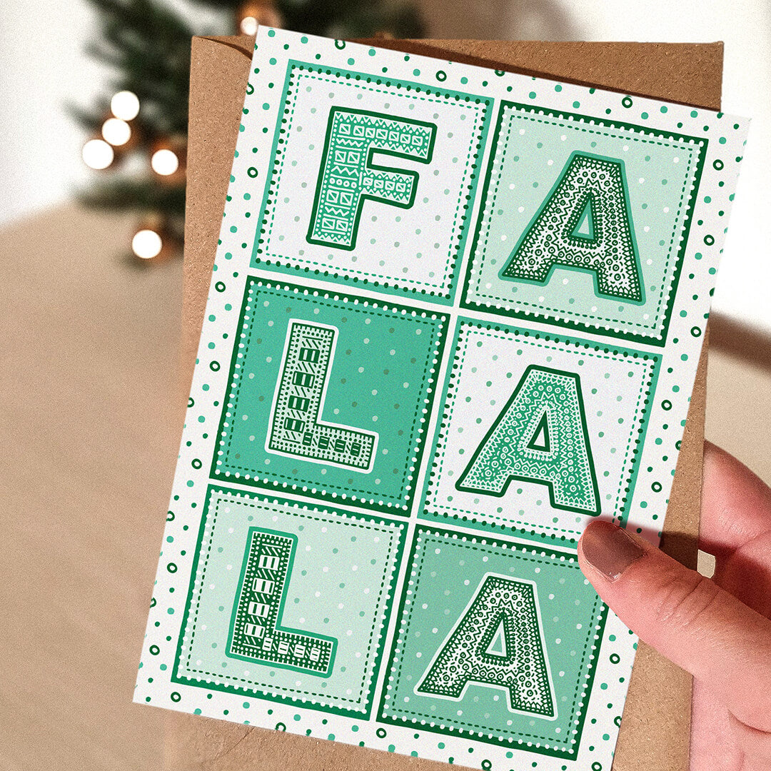 Hand holding Green typographic Fa La La Christmas card Modern unique Christmas card design Printed on recycled card Supplied with kraft brown recycled envelope