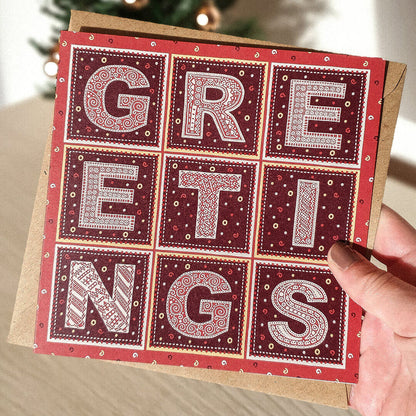 Hand holding Red traditional Christmas card Unique Greetings traditional Christmas card design Printed on recycled card Supplied with kraft brown recycled envelope