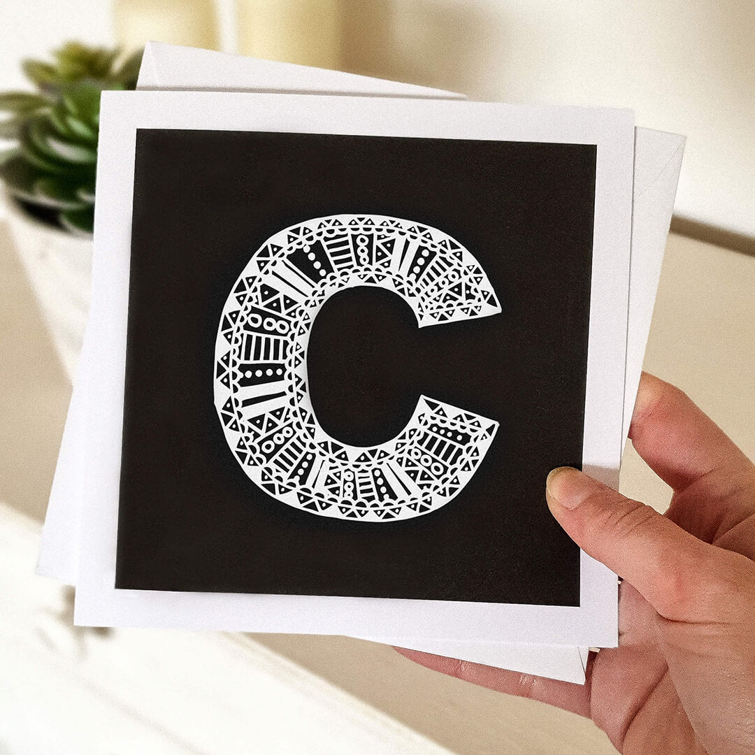 Hand holding letter C card Unique typographic greeting card Patterned black white initial greeting card Blank inside