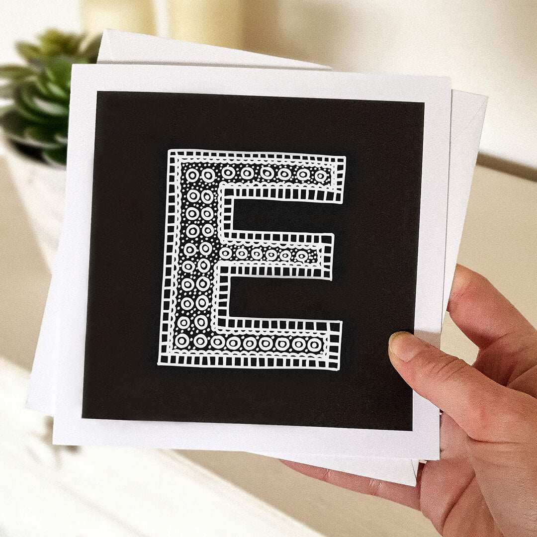 Hand holding letter E card Unique typographic greeting card Patterned black white initial greeting card Blank inside