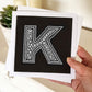 Hand holding letter K card Unique typographic greeting card Patterned black white initial greeting card Blank inside