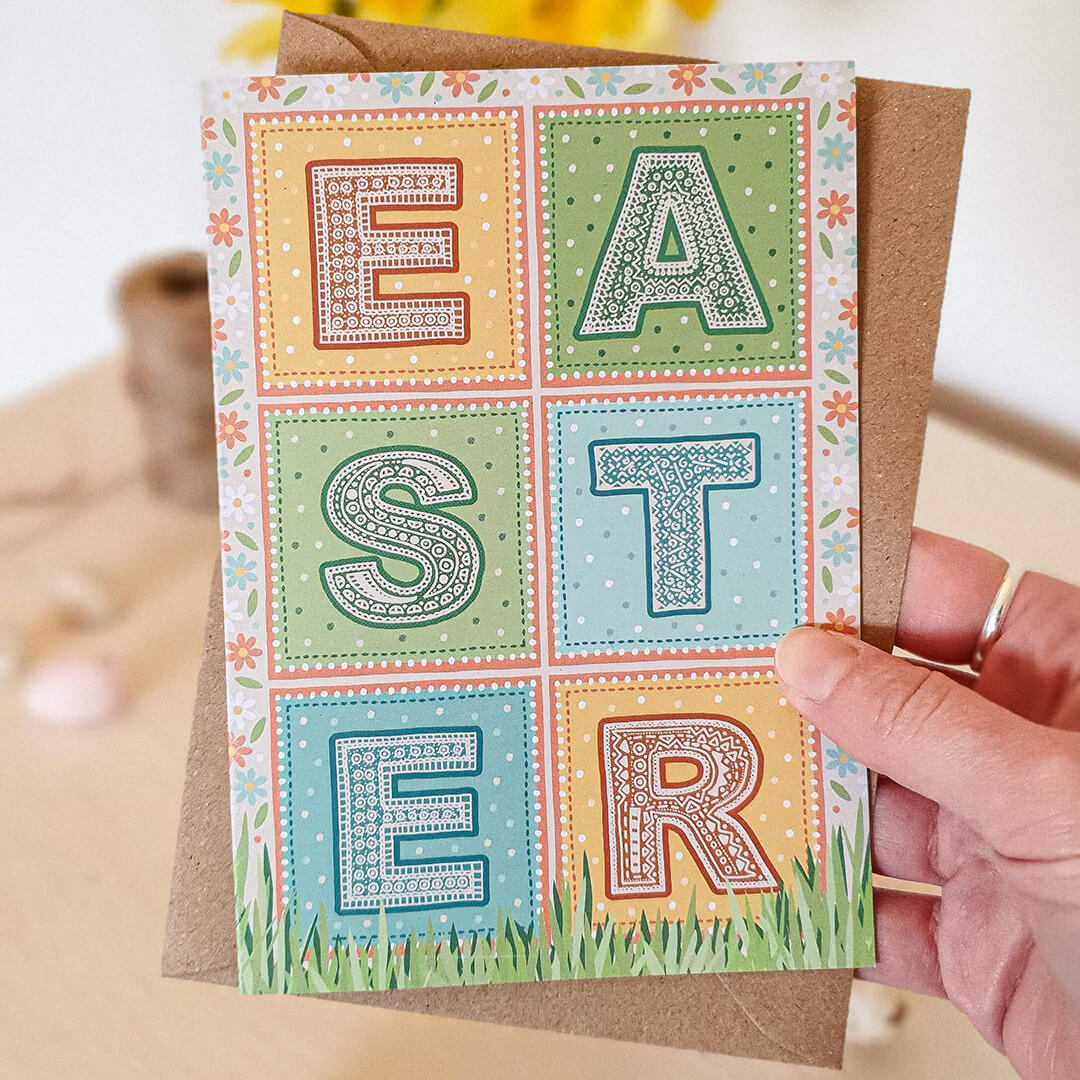 Hand holding pastel typographic Happy Easter card Unique Easter card design with patterned typography floral natural illustrations Printed on recycled card Supplied with kraft brown recycled envelope