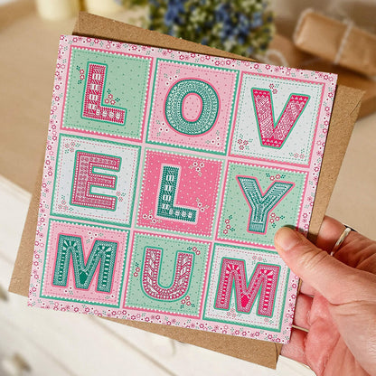 Hand holding Lovely Mum Mother's Day card design Unique Mother's Day card with pink and green floral illustrated design Printed on recycled card Supplied with kraft brown recycled envelope