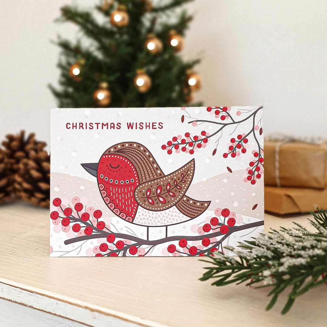 Unique illustrated robin Christmas card Cute robin Christmas card design featuring branches of festive berries Printed on recycled card Kraft brown recycled envelope