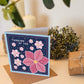 Pink blue floral thinking of you card Illustrated pink flowers Blue background Kraft brown recycled envelope Blank inside
