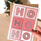 Hand holding Red white Typographic ho ho ho Christmas card Unique ho ho ho Christmas card design Printed on recycled card Supplied with kraft brown recycled envelope