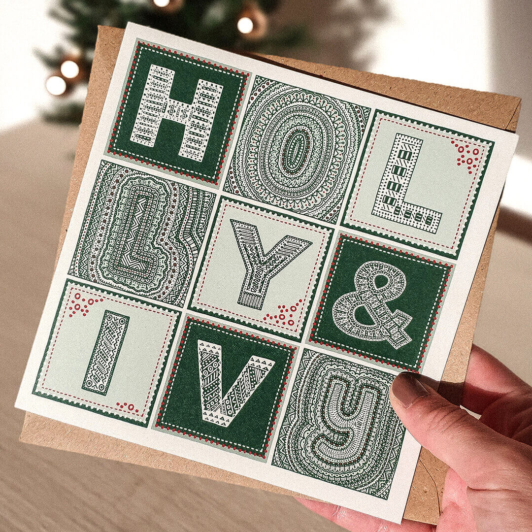 Hand holding Green Typographic holly and ivy Christmas card Unique holly and ivy Christmas card design Printed on recycled card Supplied with kraft brown recycled envelope